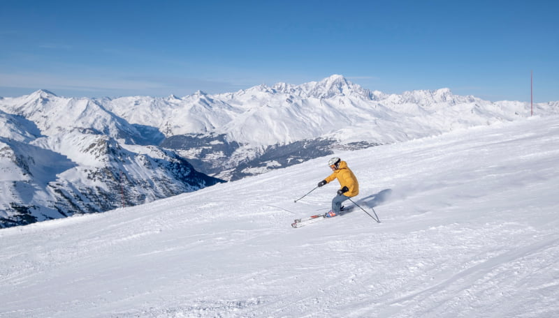 lonely skier on a slope with a view on Mont-Blanc mountain
